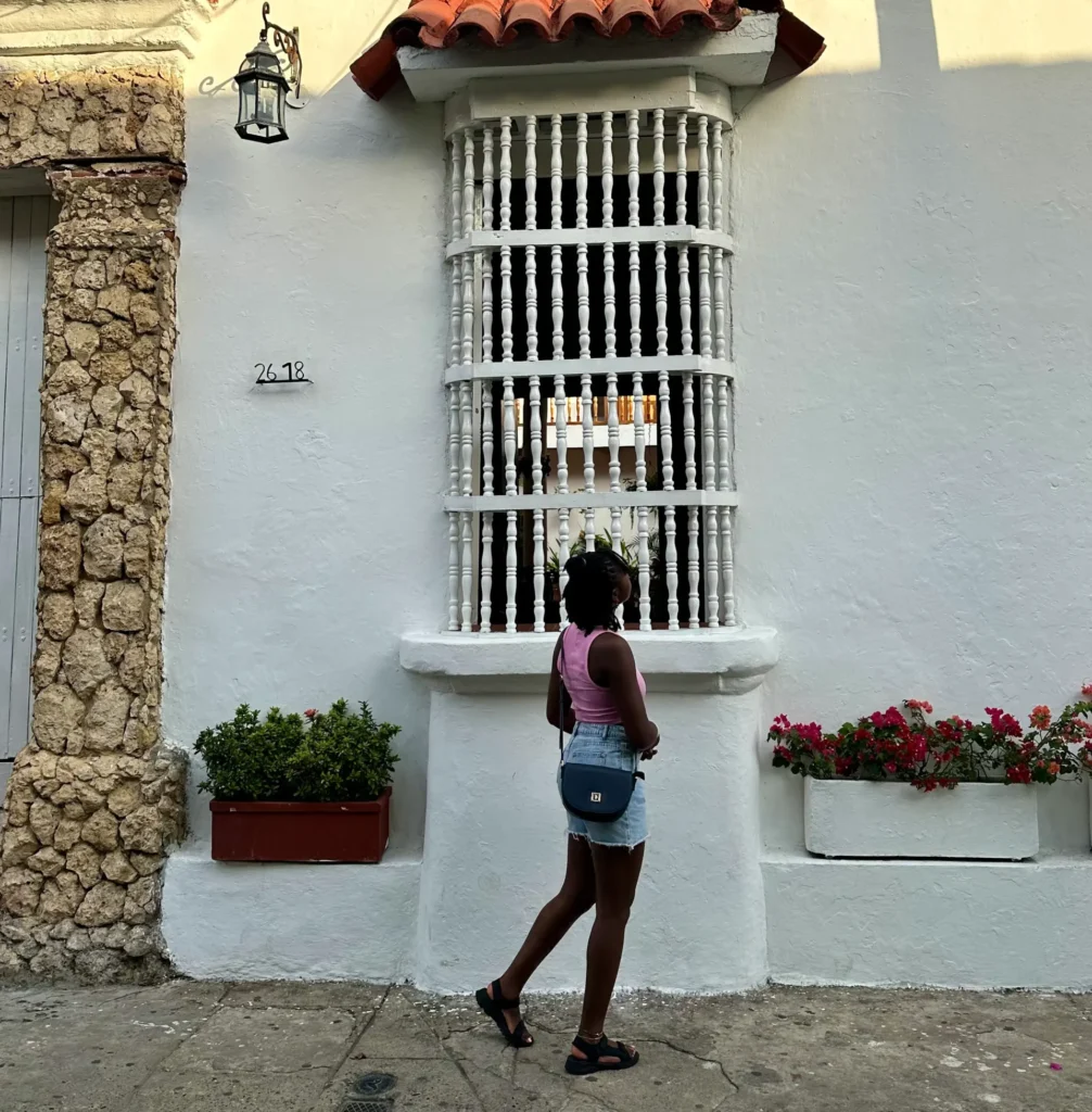 Woman walking with a crossbody bag, travel essentials concept.